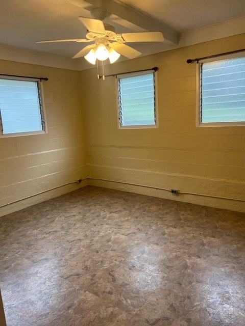 A room with a ceiling fan and two windows.